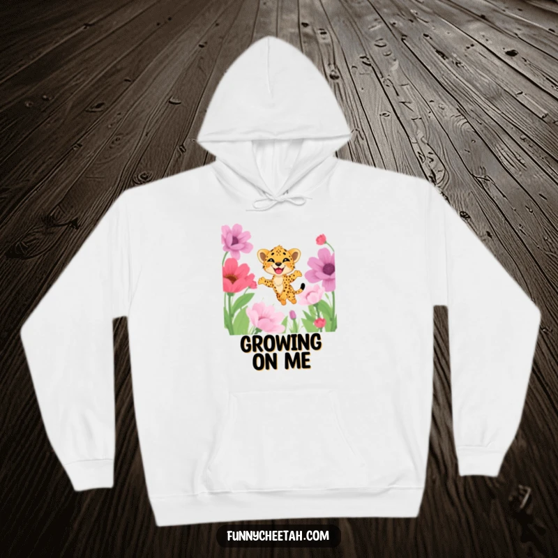 Funny hoodie with a delighted cheetah cub mid-leap through a field of giant flowers, embodying pure joy, comfort, and playful exploration.